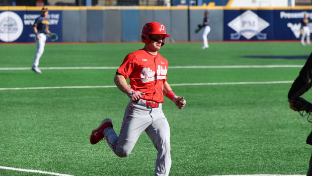 Ohio State senior Joseph Mershon crosses home plate in the first inning.